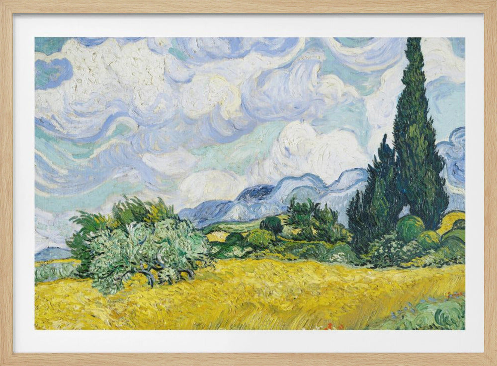 A framed print of Vincent van Gogh's painting 'Wheat Field with Cypresses.' The artwork depicts a vibrant golden wheat field under a dynamic sky filled with swirling white and blue clouds. A tall, dark green cypress tree dominates the right side, with rolling green hills and distant blue mountains in the background. Decor