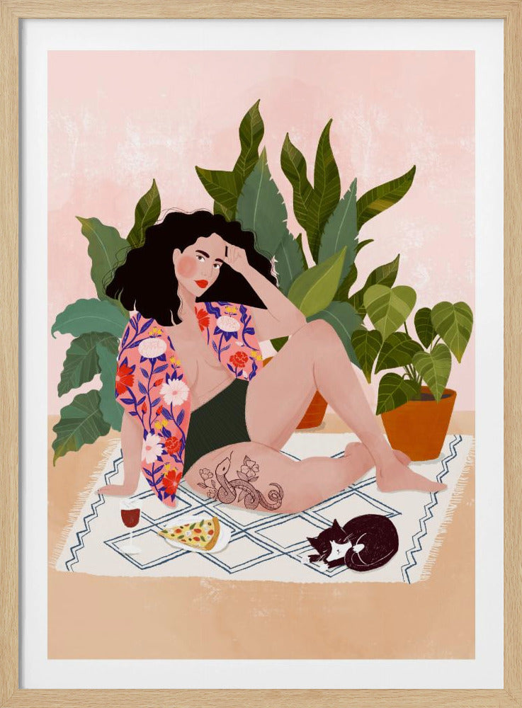 An illustration of a woman with dark curly hair relaxing on a patterned blanket indoors. She is wearing a green swimsuit and a pink floral shirt, with a prominent snake tattoo on her thigh. Next to her is a slice of pizza, a glass of red wine, and a sleeping black and white cat, all set against a backdrop of large green houseplants and a pink wall. Artwork
