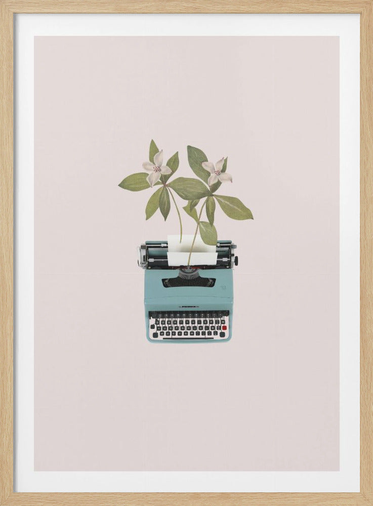A framed artwork depicting a light blue vintage typewriter on a pale pink background, with two white flowers and green leaves growing out of the paper slot. Artwork