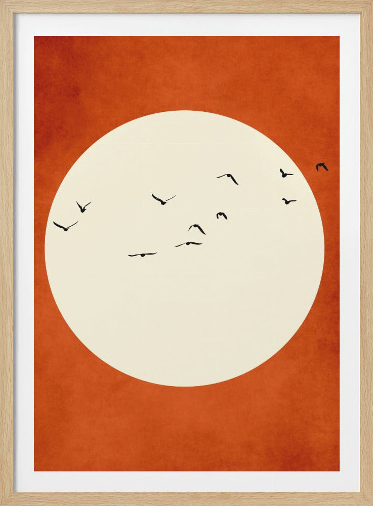 A minimalist art piece featuring a flock of black bird silhouettes flying across a large cream-colored circle, representing the sun or moon, set against a textured burnt orange background and enclosed in a black frame. Wall Art