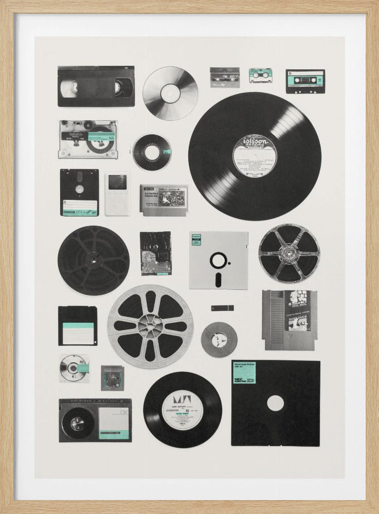 A framed black and white art print featuring a flat lay arrangement of various vintage media formats. The collection includes vinyl records, a VHS tape, cassette tapes, floppy disks, film reels, a CD, an old iPod, and video game cartridges, all neatly organized on an off-white background. Artwork