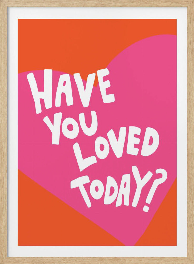 A framed art print with the text 'Have you loved today?' in a playful white font. The text is centered on a large pink heart which is set against a vibrant orange background. Artwork