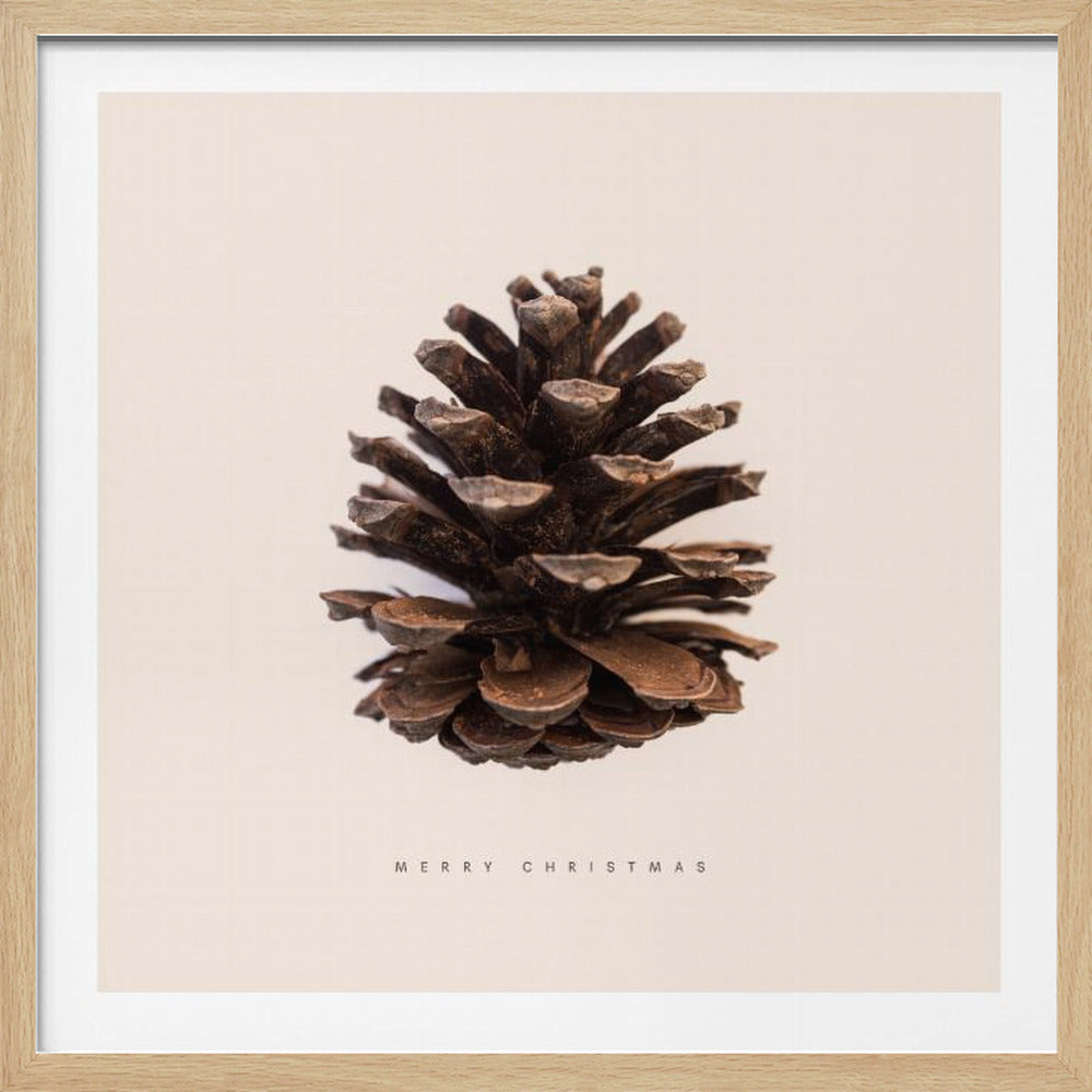 A minimalist art print featuring a single brown pinecone centered on an off-white background. The words 'MERRY CHRISTMAS' are printed in a simple, spaced-out font below the pinecone. The entire image is enclosed in a light wood frame. Artwork
