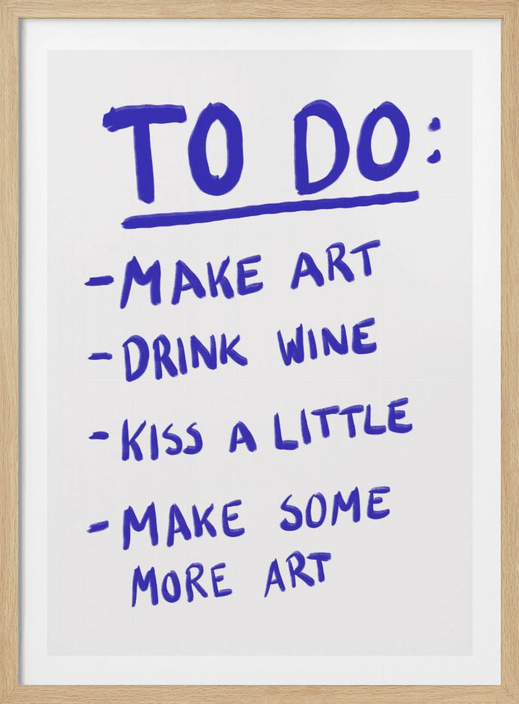 A framed white poster with a handwritten 'TO DO:' list in bold blue marker. The list includes the items: 'MAKE ART', 'DRINK WINE', 'KISS A LITTLE', and 'MAKE SOME MORE ART'. Print