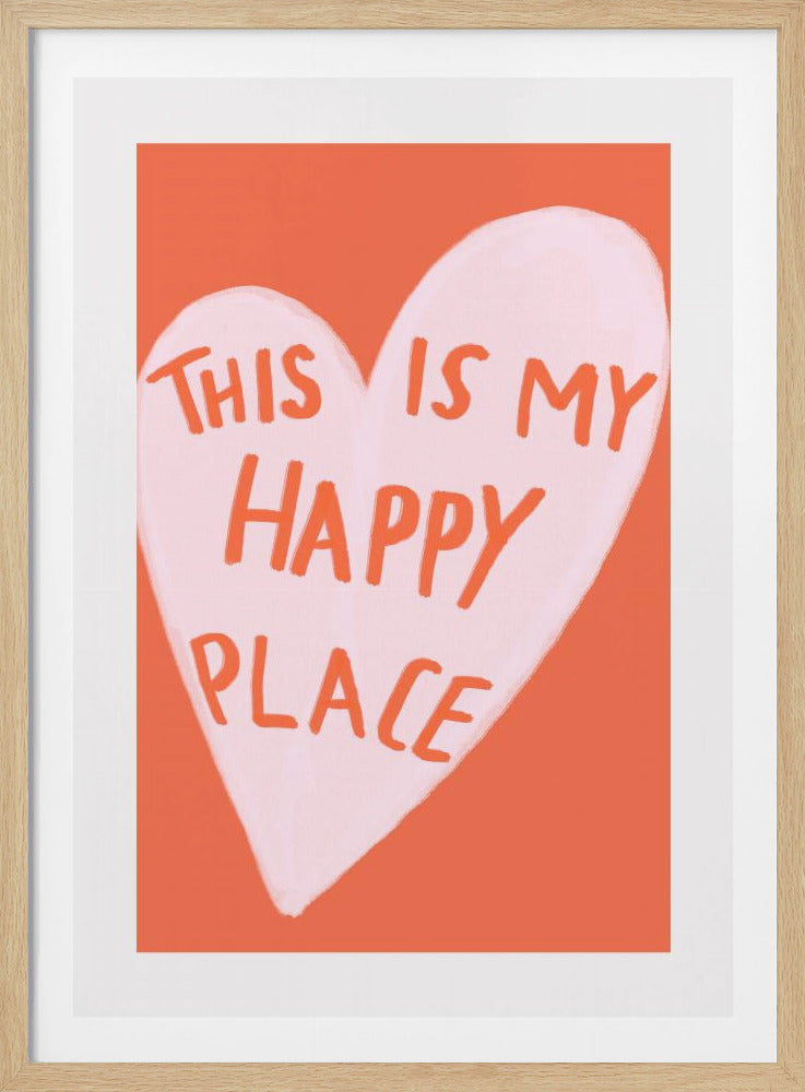 A framed art print featuring a light pink hand-drawn heart on a solid coral-orange background. Inside the heart, the phrase 'THIS IS MY HAPPY PLACE' is written in a casual, handwritten orange font. Artwork