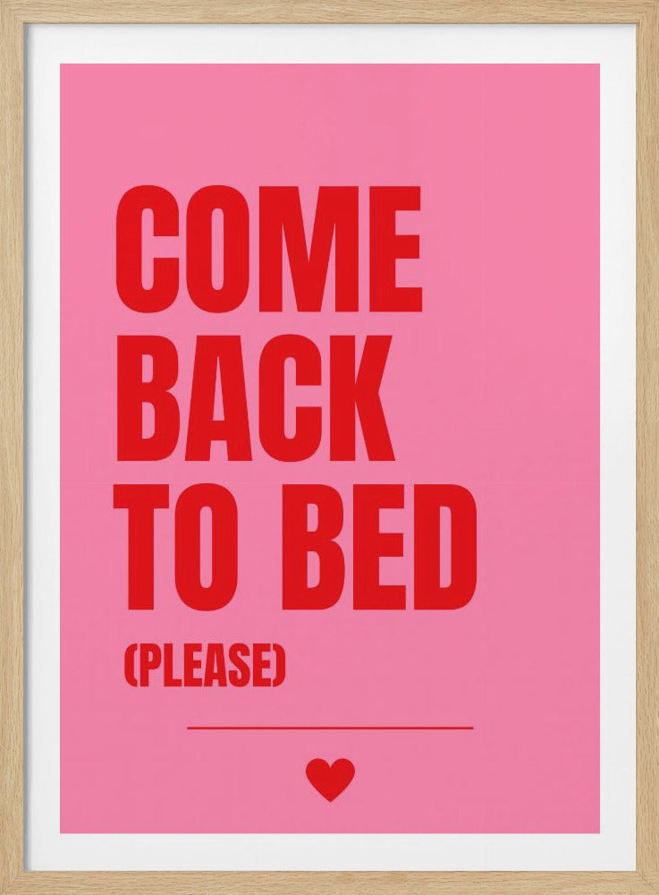 A framed poster with a pink background and bold red text. The text reads 'COME BACK TO BED' in all caps, with the words stacked. Below, in smaller letters, it says '(PLEASE)'. A small red heart is centered at the very bottom above a horizontal line. Artwork