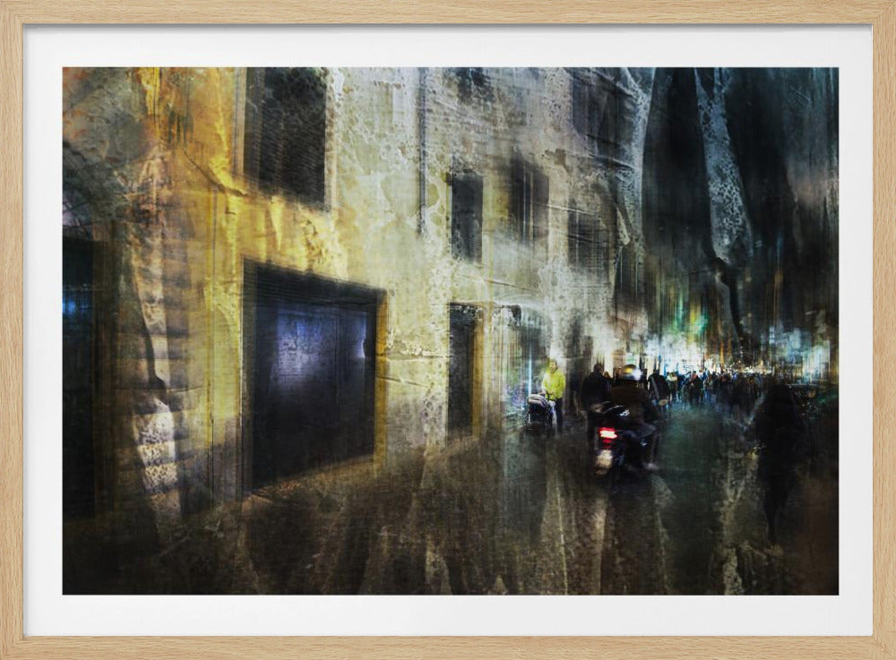 A framed abstract digital artwork depicting a busy, narrow city street at night. The image has a heavily textured, painterly style, with blurred motion effects. A weathered, yellow-lit building is on the left, while the street on the right is filled with indistinct figures of people and a motorcycle, with city lights glowing in the distance. Wall Art