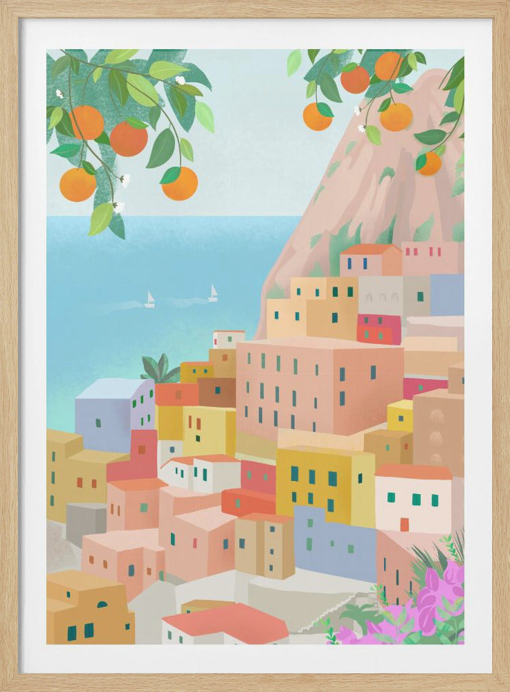 A vibrant illustration of a colorful coastal village nestled on a cliffside. In the foreground, orange tree branches with ripe fruit hang over the scene. The village is composed of pastel-colored buildings in shades of pink, yellow, and blue. In the background, the calm blue sea features two small sailboats. Decor