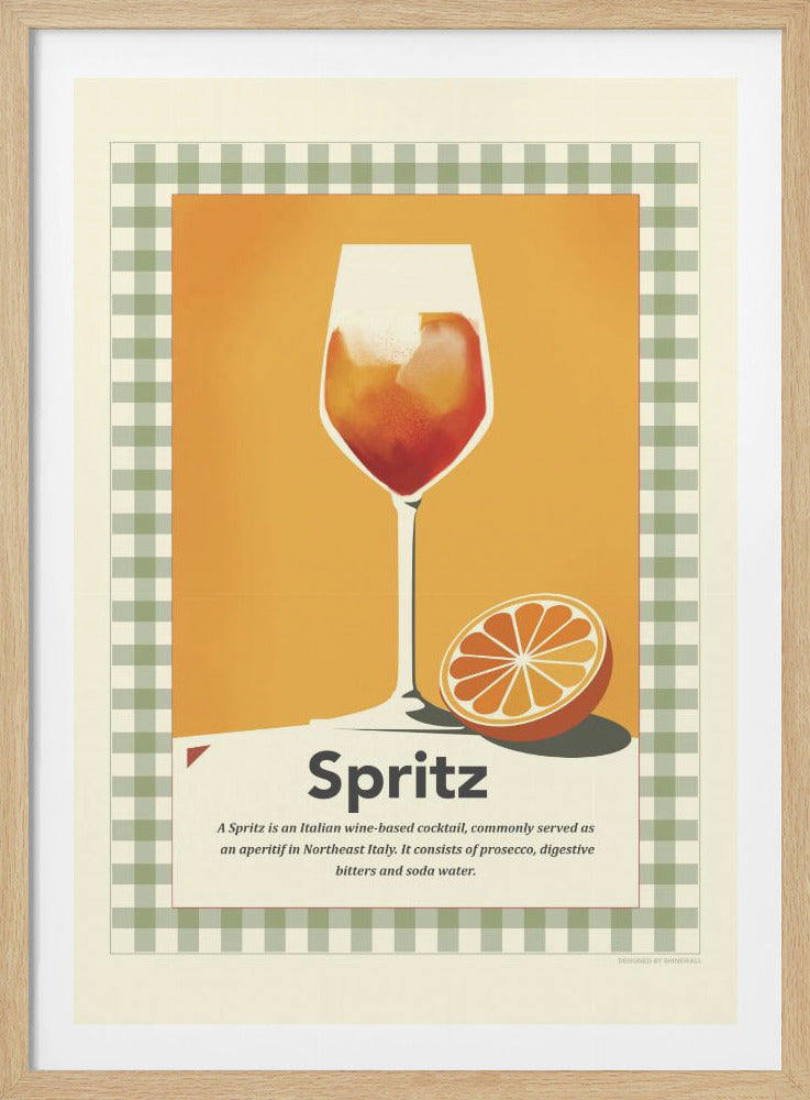 A framed, vintage-style poster advertising a Spritz cocktail. The illustration features a wine glass filled with the orange-hued drink and an orange slice next to it, set against a solid orange background. A green and white gingham border frames the central image, and text below the drink defines what a Spritz is. Wall Art