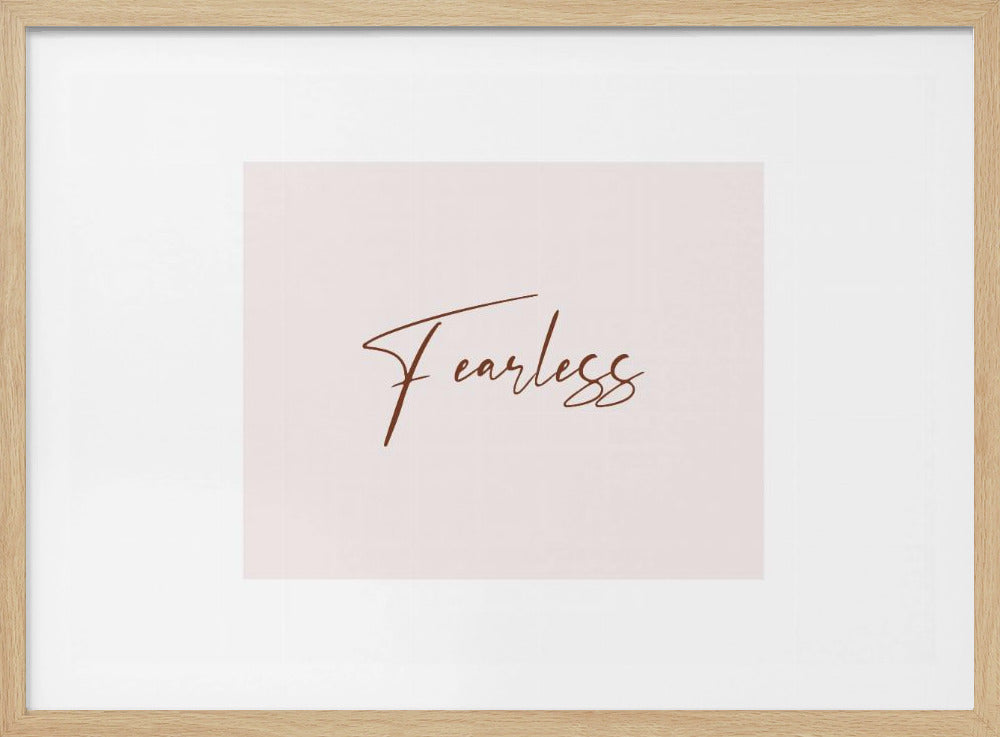 A framed artwork featuring the word 'Fearless' in a flowing brown script font on a pale pink background. The piece is surrounded by a white mat and a textured silver frame. Wall Art
