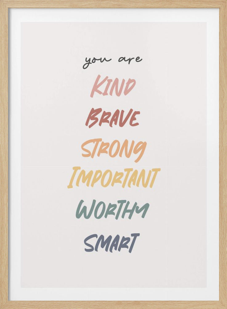 A framed motivational poster with a white background. The text begins with 'you are' in small black script, followed by a colorful list of affirmations: KIND, BRAVE, STRONG, IMPORTANT, WORTHY, SMART, each in a unique color and brushstroke font. Artwork