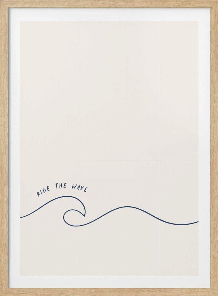 A minimalist art print in a black frame featuring a single dark blue line that forms a simple ocean wave on an off-white background. The words 'RIDE THE WAVE' are written in a casual, handwritten font above the crest. Wall Art