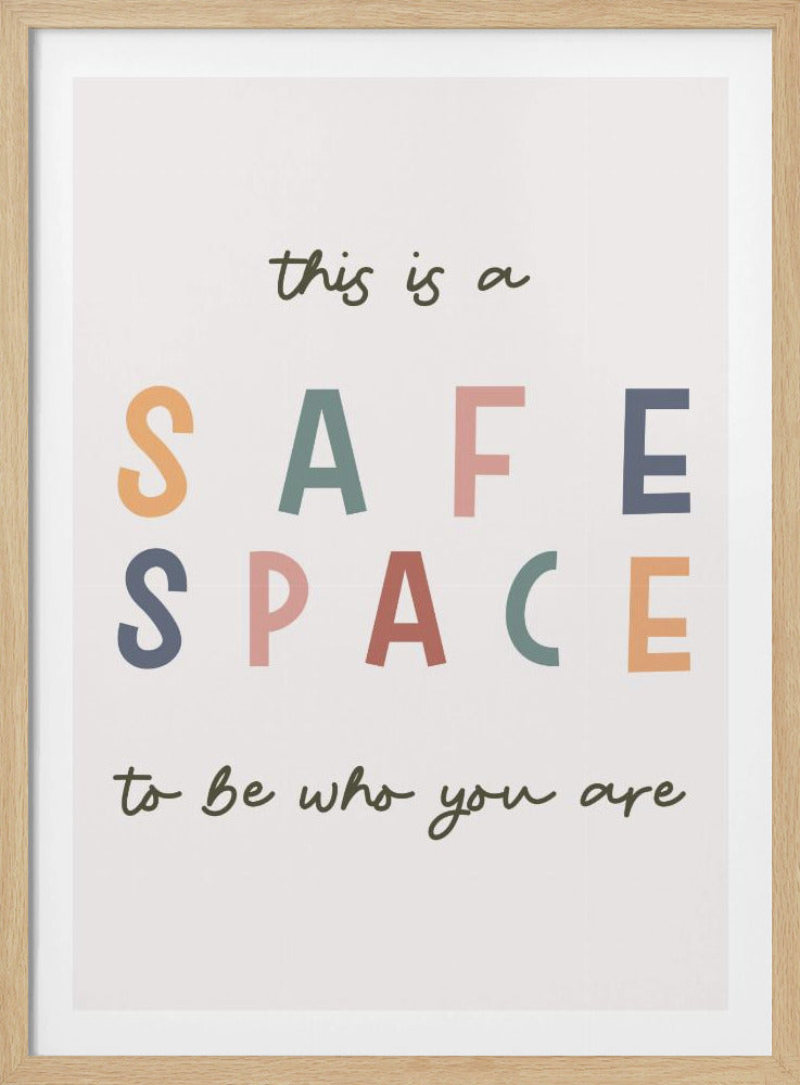 A framed poster with an inspirational message that reads 'this is a SAFE SPACE to be who you are'. The words 'SAFE SPACE' are in large, block letters of various muted colors like orange, sage, pink, and blue, while the rest of the text is in a smaller, dark green script font on an off-white background. Poster