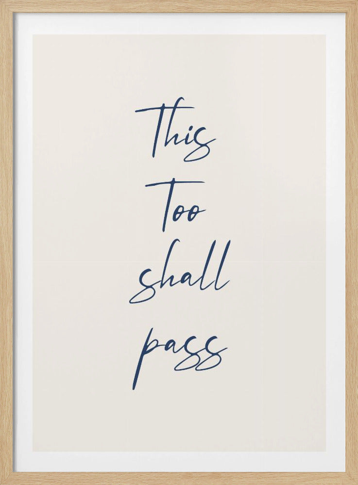 A framed art print featuring the inspirational quote 'This Too shall pass' in a dark blue, elegant cursive script against a simple cream background. The piece is bordered by a thin black frame. Poster