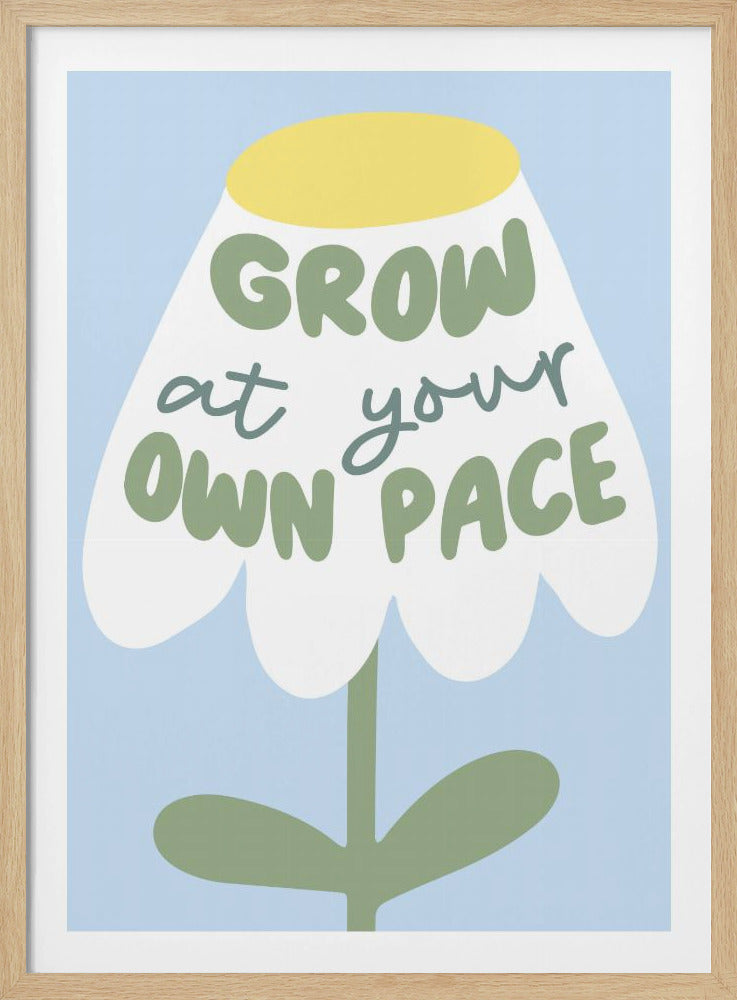 A motivational art print featuring a stylized white flower with a yellow center and green stem against a light blue background. The phrase 'GROW at your OWN PACE' is written in green, hand-drawn lettering across the flower's petals. Artwork