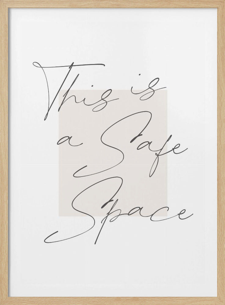 A minimalist art print in a black frame with the words 'This is a Safe Space' written in a flowing black cursive script over a pale beige rectangle on a white background. Artwork