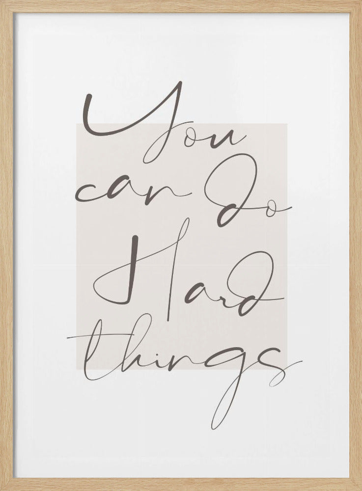 A minimalist framed art print featuring the motivational quote 'You can do hard things'. The text is written in a dark grey, elegant script font over a light beige rectangular background, all set against a white matting within a thin black frame. Poster
