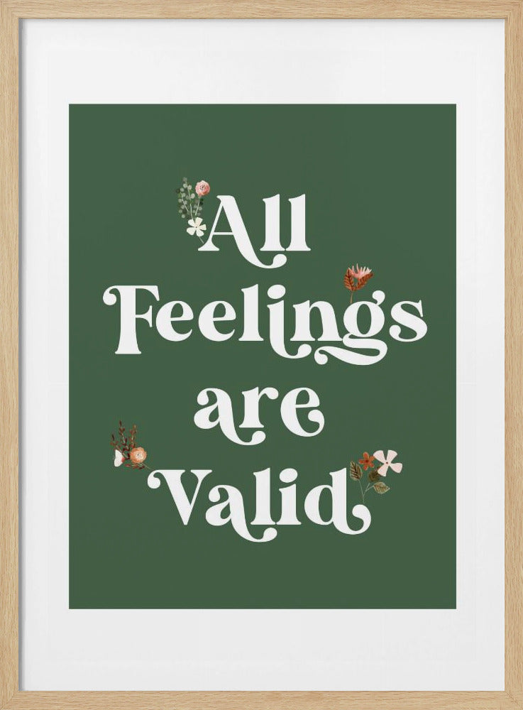 A framed poster with a dark sage green background and the text 'All Feelings are Valid' in a stylized white serif font. Small, delicate floral illustrations are scattered around the words. Poster