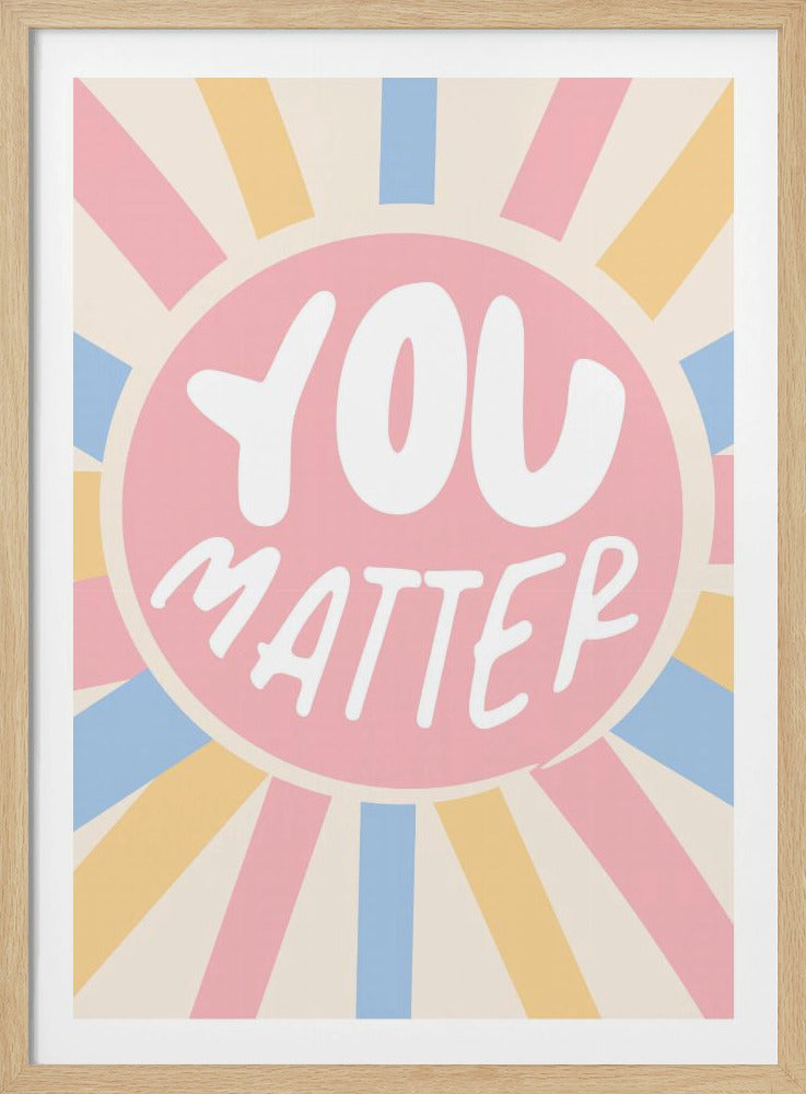 A retro-style art print with a positive message. In the center, a pink circle contains the words 'YOU MATTER' in a white, rounded font. Radiating from the center are sunbeams in pastel shades of pink, blue, and yellow against a cream-colored background. Print