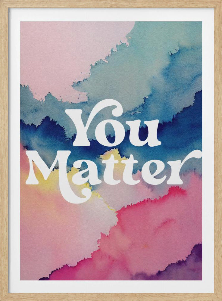 An inspirational art print featuring the words 'You Matter' in a white, stylized serif font. The text is centered over a vibrant abstract watercolor background that blends shades of pink, blue, and yellow. The artwork is enclosed in a thin black frame. Poster