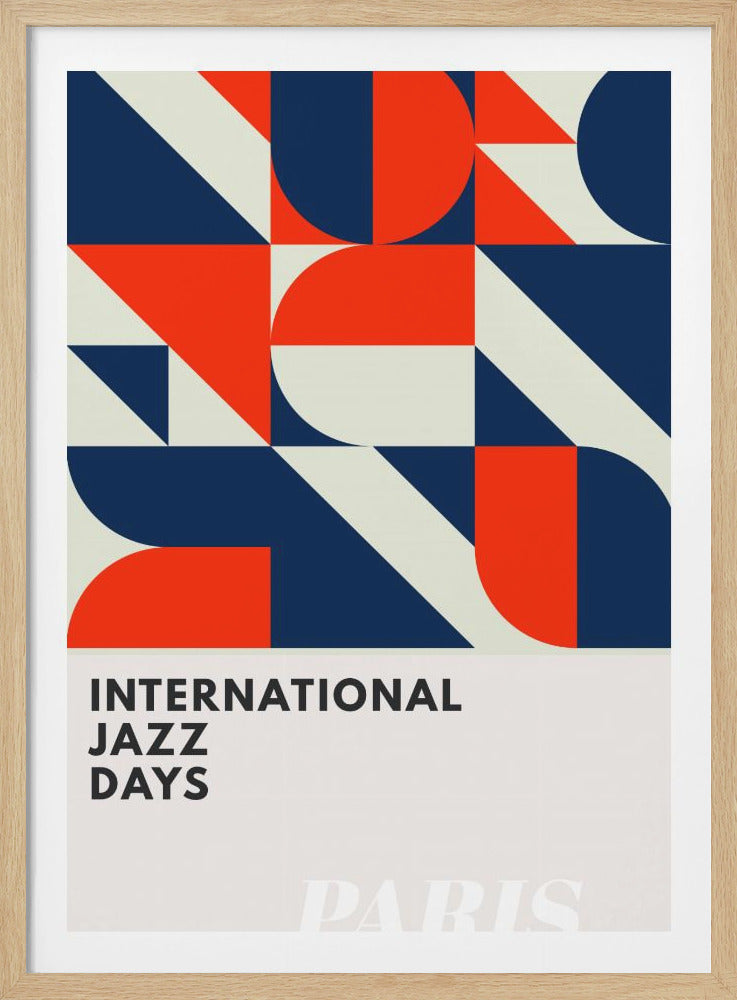 A framed graphic poster for 'International Jazz Days'. The top section features a bold geometric pattern in a grid of squares, using shapes and blocks of red, dark blue, and off-white. The bottom third is off-white with the words 'INTERNATIONAL JAZZ DAYS' in a black sans-serif font. Wall Art