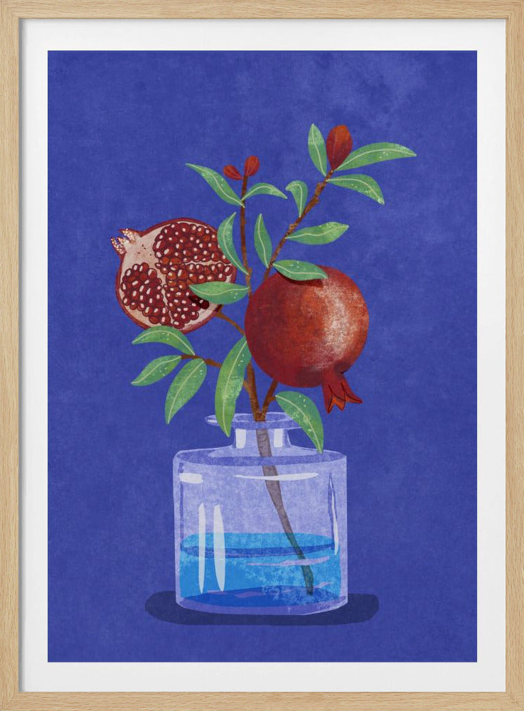 A vibrant illustration of a pomegranate branch in a clear glass vase against a deep blue, textured background. The branch features bright green leaves, a whole red pomegranate, and another cut in half to show its seeds. Decor