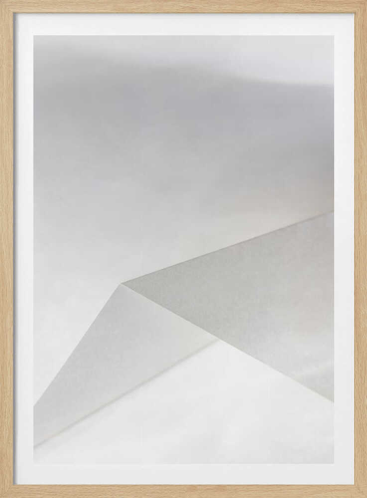 Minimalist abstract art of folded paper creating clean lines and geometric shapes in shades of grey and white.