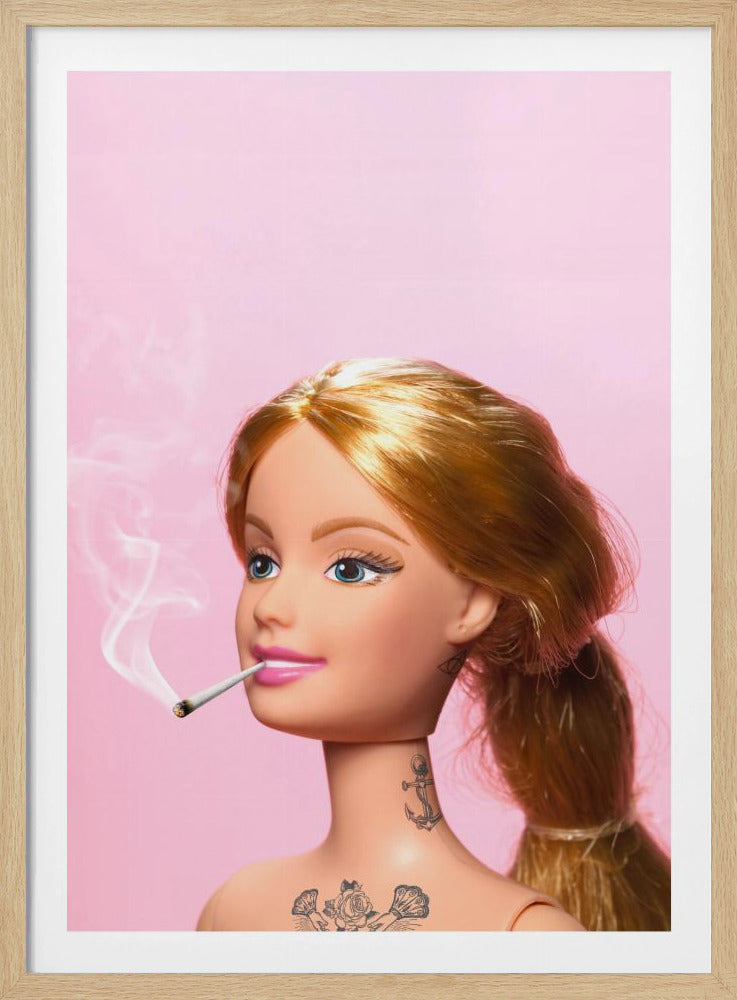 A close-up photograph of a blonde doll, resembling Barbie, with tattoos on her neck and chest, smoking a joint against a solid pink background. Smoke curls upwards from the lit cigarette in her pink-lipsticked mouth. Artwork