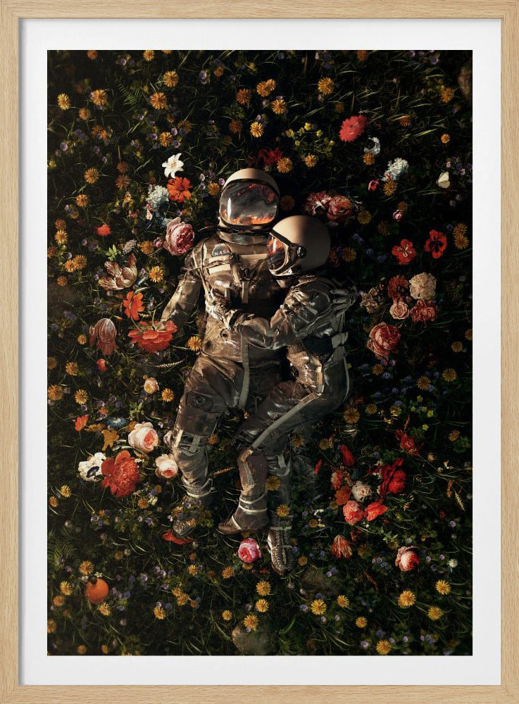 An overhead view of two astronauts in full gear, embracing each other while lying down in a lush, dark field filled with a vibrant array of colorful flowers. Wall Art