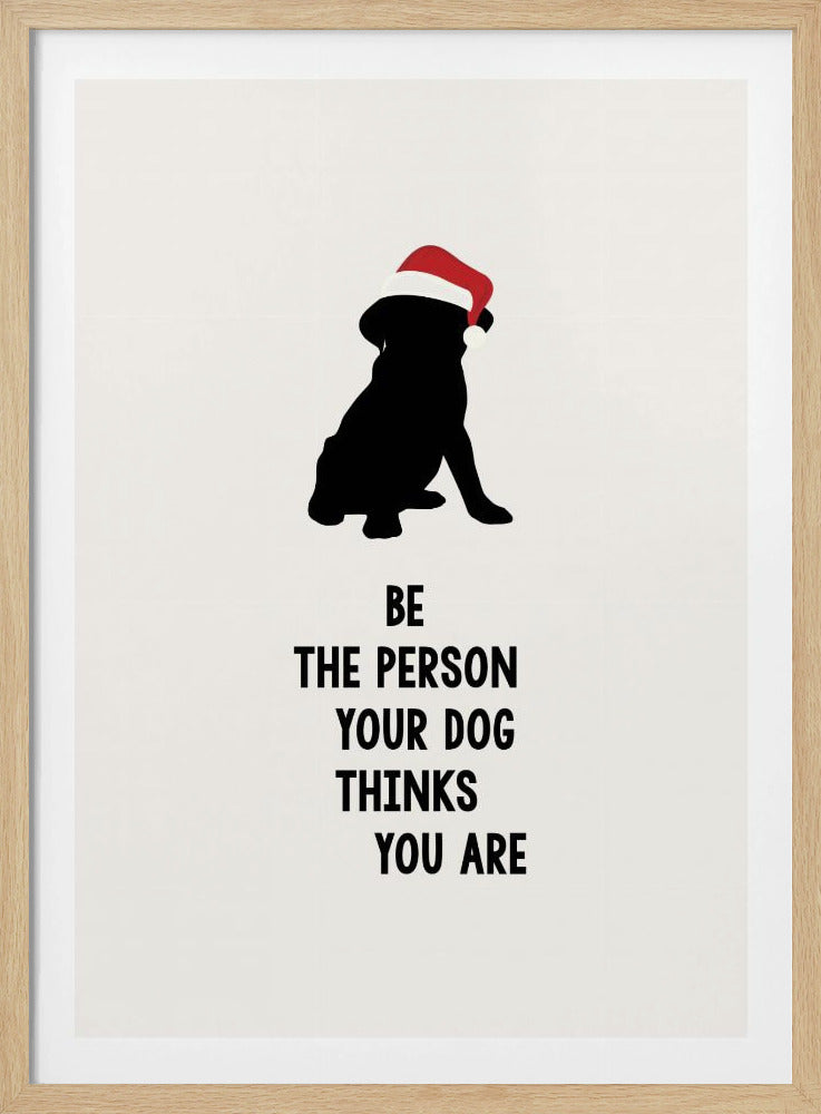 A framed art print featuring a black silhouette of a dog wearing a red Santa hat on an off-white background. Below the dog is the motivational quote, 'BE THE PERSON YOUR DOG THINKS YOU ARE' in black block letters. Decor