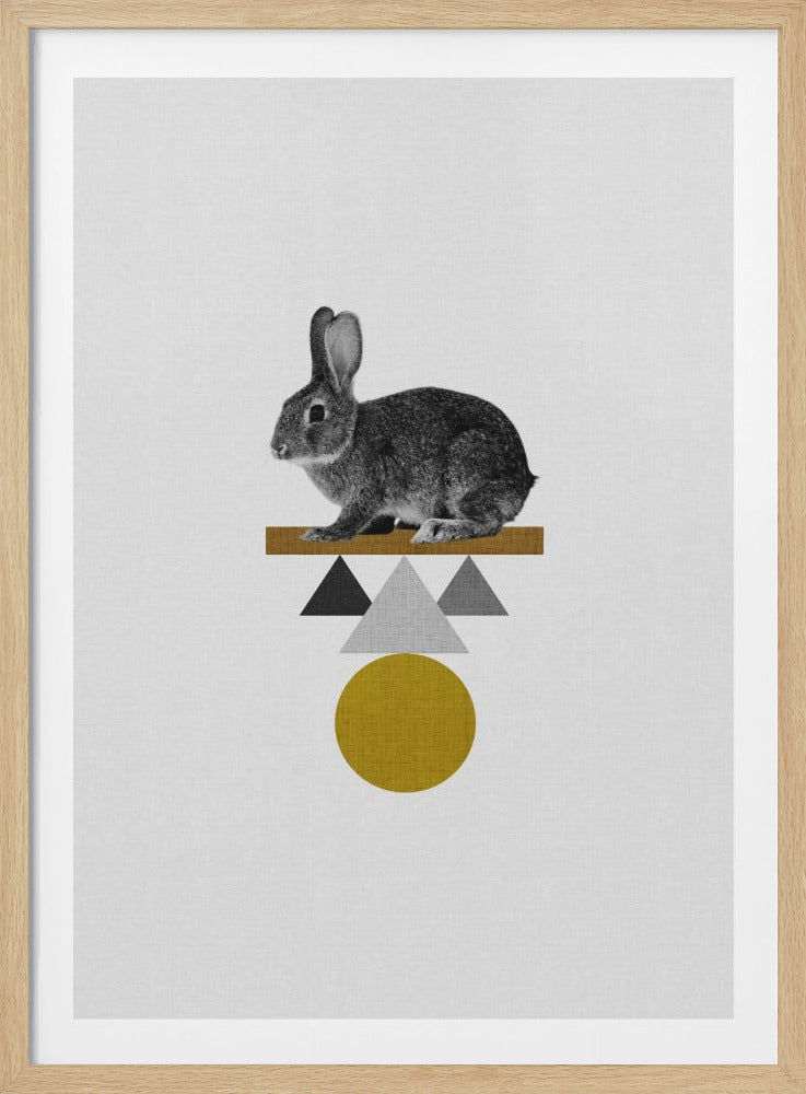 A modern art piece featuring a black and white photo of a small rabbit sitting on top of a stack of geometric shapes. The shapes include a textured ochre rectangle, grey and black triangles, and a large textured ochre circle, all set against an off-white, canvas-like background. Wall Art