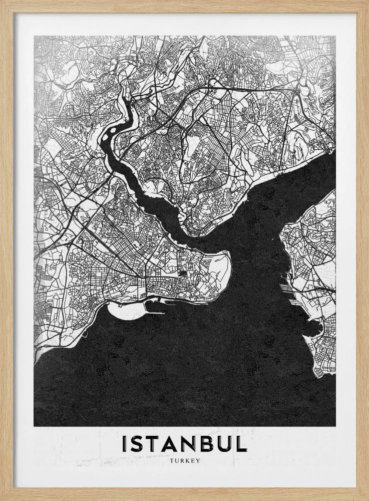 A modern black and white framed poster of a city map of Istanbul. The land is depicted in white with intricate black lines representing streets, while the bodies of water like the Bosphorus are shown in solid textured black. A white banner at the bottom displays the word 'ISTANBUL' in a bold, black, sans-serif font. Artwork