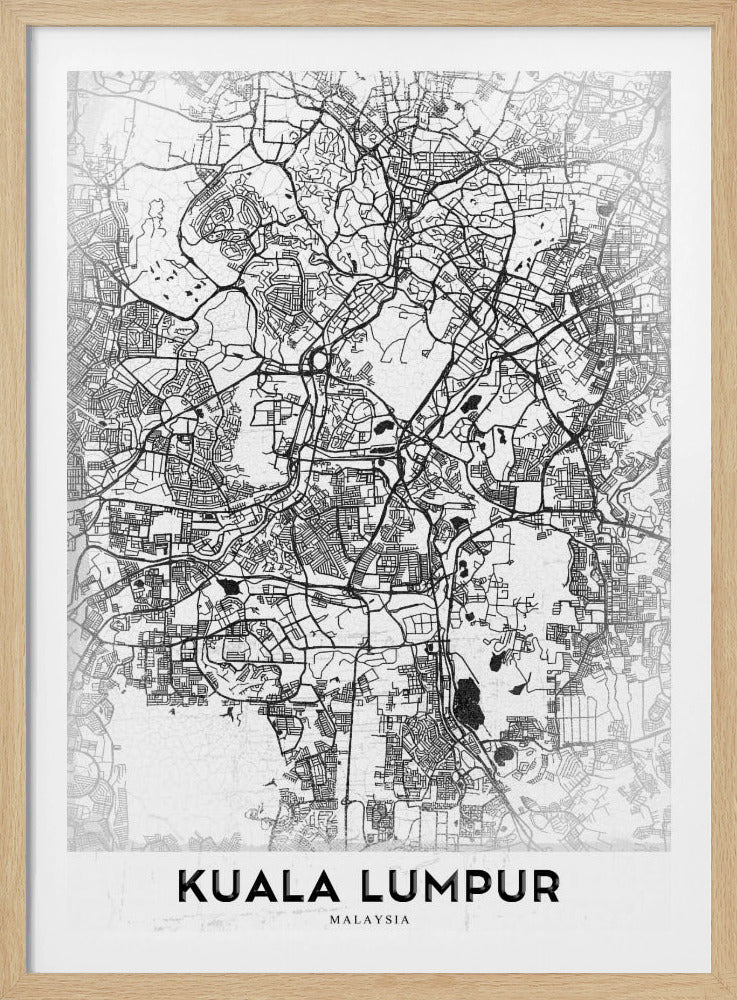 A minimalist black and white street map of Kuala Lumpur, displayed in a black frame. The map shows a detailed network of roads and city blocks on a textured white background. The name "KUALA LUMPUR" is printed in a bold, modern font at the bottom. Decor