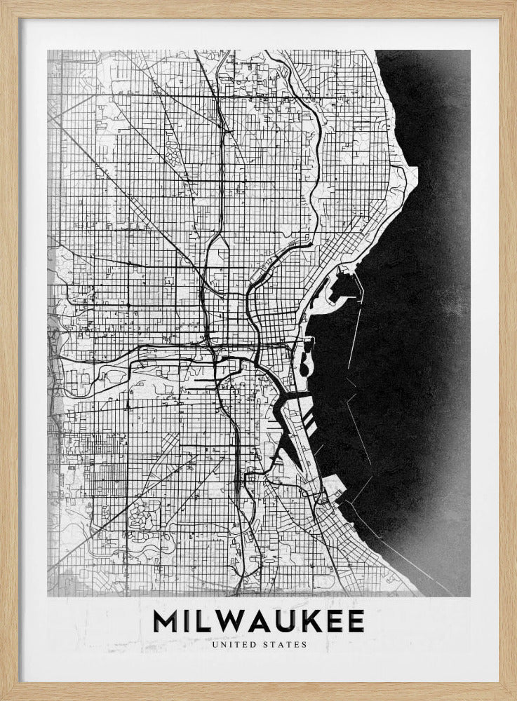A minimalist, black and white street map of Milwaukee, displayed in a black frame. The map details the city's grid system, major roads, and waterways against a textured background, with the word 'MILWAUKEE' in a bold, sans-serif font at the bottom. Poster