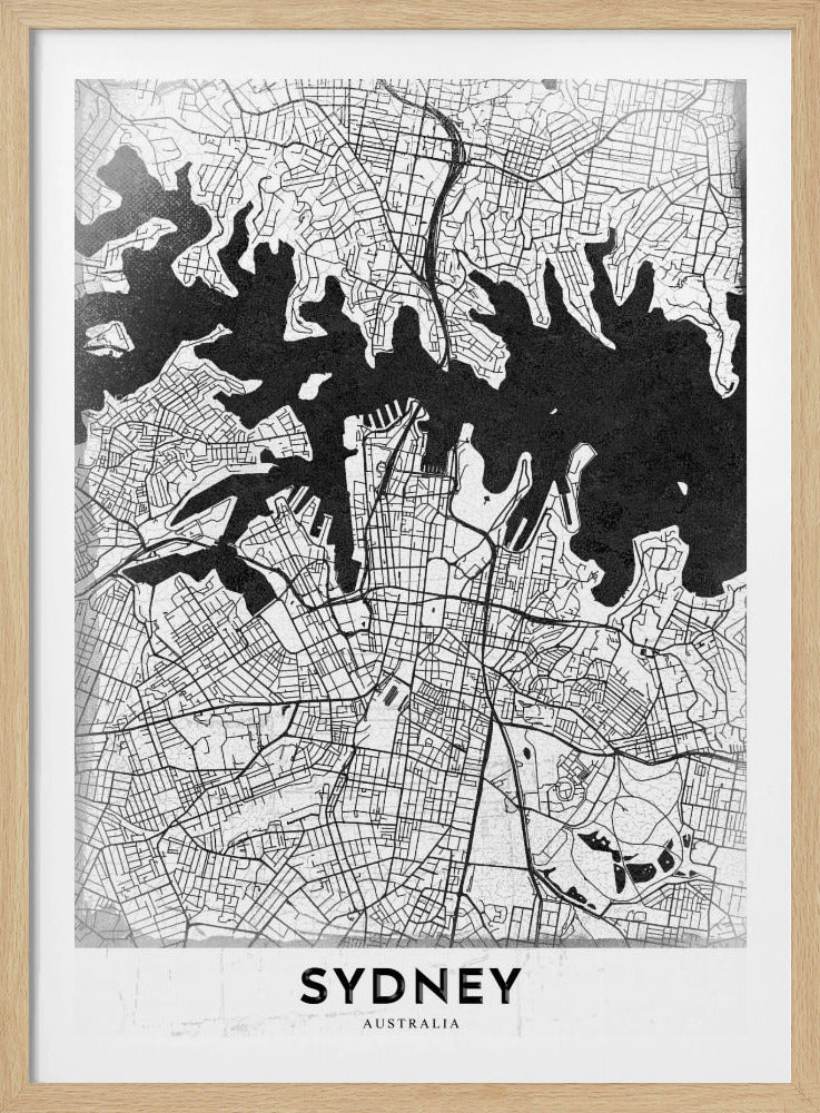 A modern black and white framed art print of a city map of Sydney, Australia. The water bodies are shown in solid textured black, while the land is depicted with a detailed white street grid. At the bottom, the word 'SYDNEY' is printed in bold capital letters. Poster