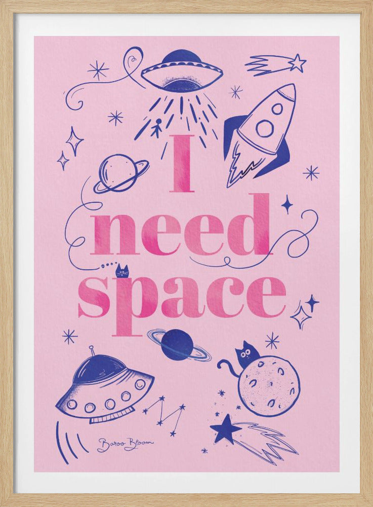 A whimsical, hand-drawn poster with a pink background and a black frame. The poster features the text 'I need space' in large, dark pink letters, surrounded by blue doodles of space elements like UFOs, a rocket ship, planets, stars, and a cat sitting on the moon. Artwork
