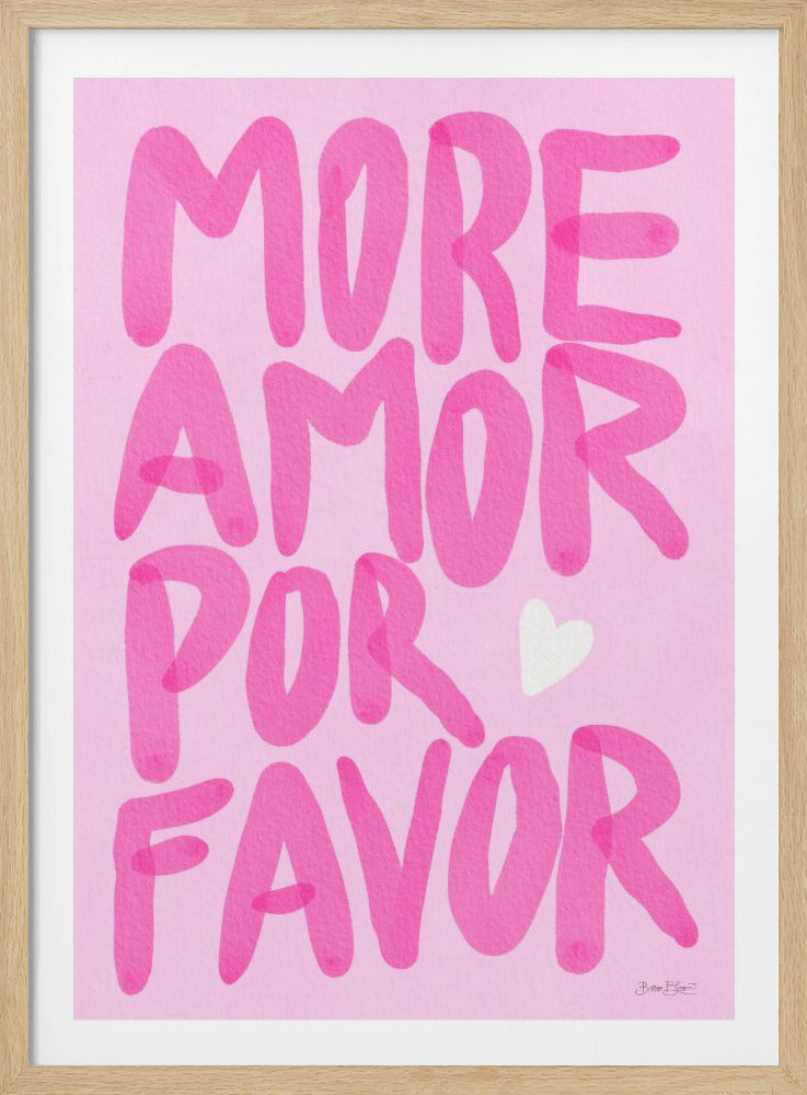 A framed art print featuring the phrase 'MORE AMOR POR FAVOR' in a bold, bubbly, hand-painted magenta font against a light pink background. A small white heart is tucked between the words 'POR' and 'FAVOR'. Wall Art