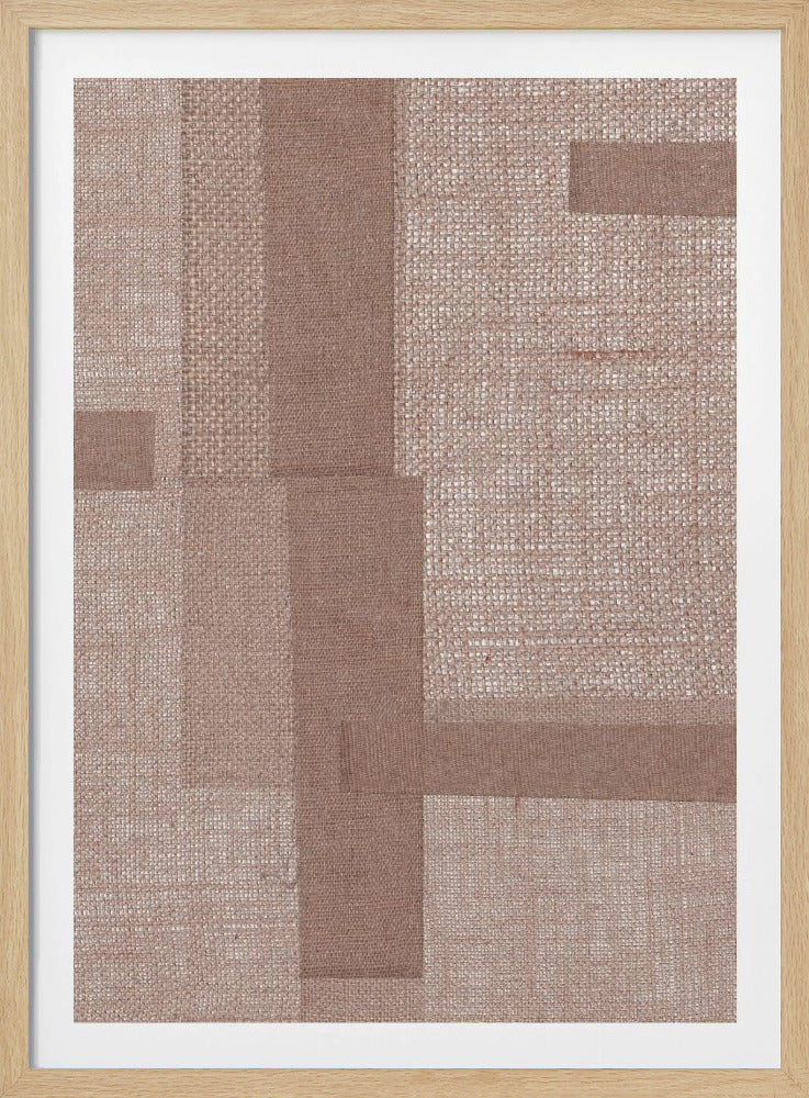 A framed abstract artwork featuring a geometric collage of overlapping rectangular pieces of textured fabric. The fabrics are in various shades of muted brown and beige with different weaves, creating a tactile and layered composition. The piece is enclosed in a simple black frame. Artwork