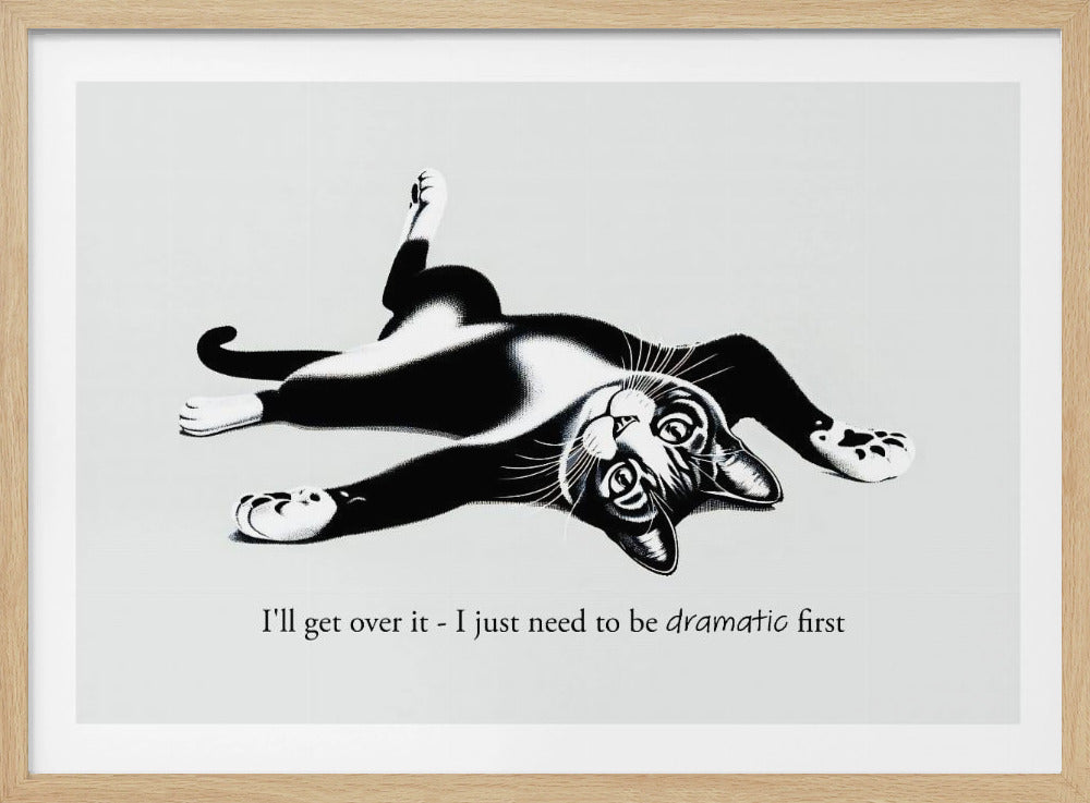 A framed black and white illustration of a tuxedo cat lying playfully on its back. Below the image is the text, 'I'll get over it - I just need to be dramatic first'. Artwork