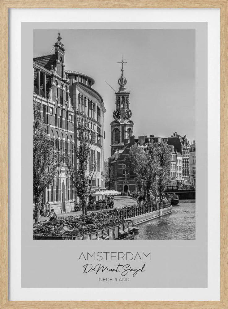 A black and white travel poster of Amsterdam, Netherlands. The photo shows the Munttoren clock tower and traditional Dutch buildings along the Singel canal. A floating barge filled with bicycles is in the foreground. The poster has a white border with the text 'AMSTERDAM', 'De Munt, Singel', and 'NEDERLAND' at the bottom. Artwork