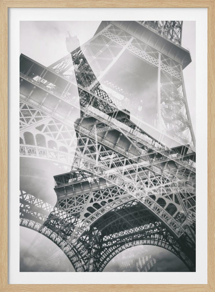 A dynamic black and white photograph of the Eiffel Tower using a double exposure technique. Different angles of the iconic iron lattice structure are layered on top of each other, creating an abstract and complex architectural composition. Print
