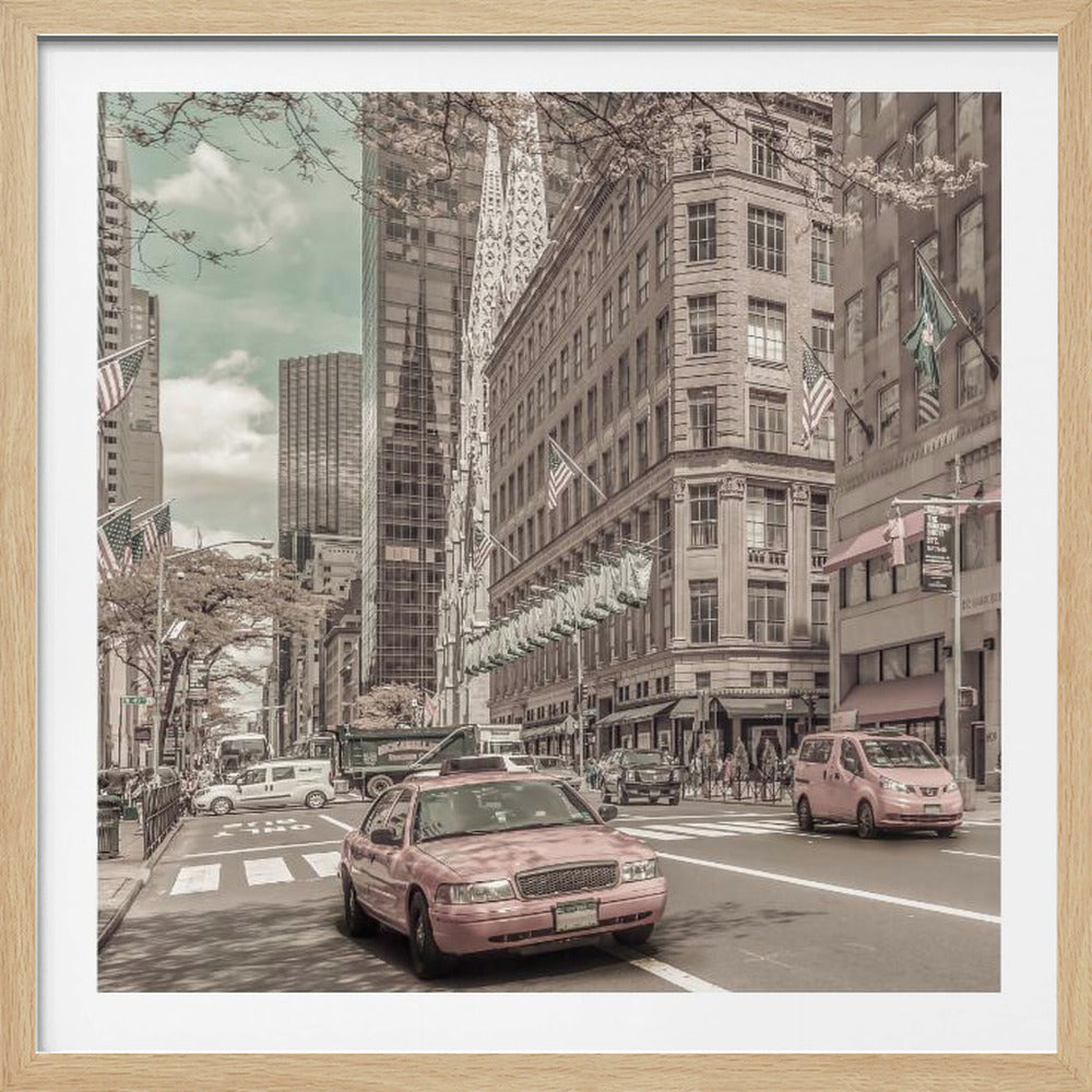 A framed photograph of a busy New York City street with a vintage, sepia-toned filter. Two cars, one in the foreground and one in the midground, are selectively colored a dusty pink, contrasting with the muted tones of the surrounding skyscrapers, American flags, and pedestrians. The sky is a pale teal color. Poster