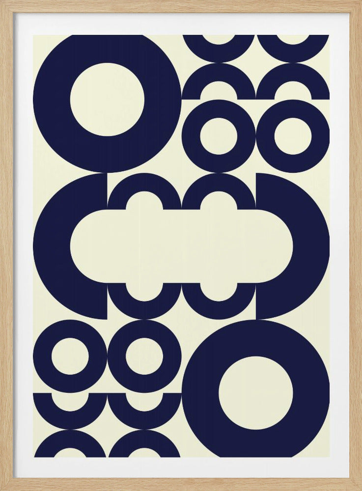 A modern abstract art print in a black frame, featuring a pattern of bold navy blue circles, rings, and arcs on a cream background. The geometric shapes overlap and are cropped, creating a dynamic composition with a central negative space. Wall Art