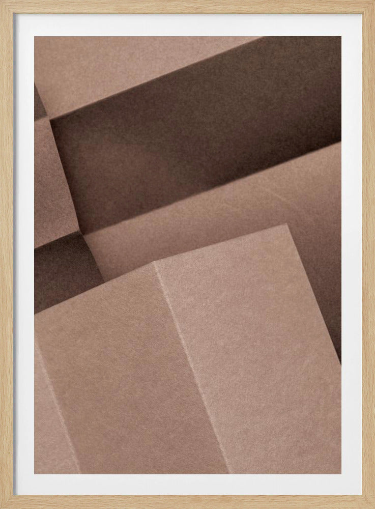 An abstract, geometric artwork in a black frame, featuring overlapping and folded planes in various shades of brown. The play of light and shadow creates a three-dimensional effect with strong diagonal lines. Poster