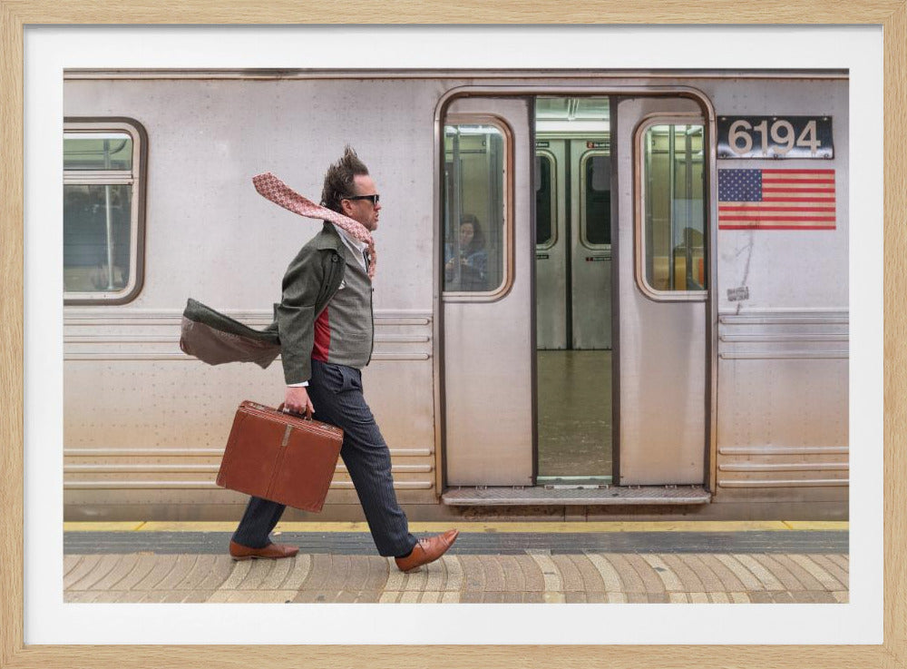 A stylish man with windblown hair and a flying scarf walks briskly along a subway platform, carrying a brown briefcase next to a silver train. Artwork