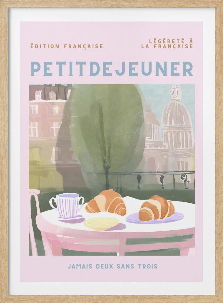 A vintage-style French poster with a light pink background. In the center, a breakfast table is set with two croissants and a striped cup, overlooking a soft-focus view of Parisian architecture. The poster has text in French, with 'PETITDEJEUNER' prominently displayed in light blue lettering. Print
