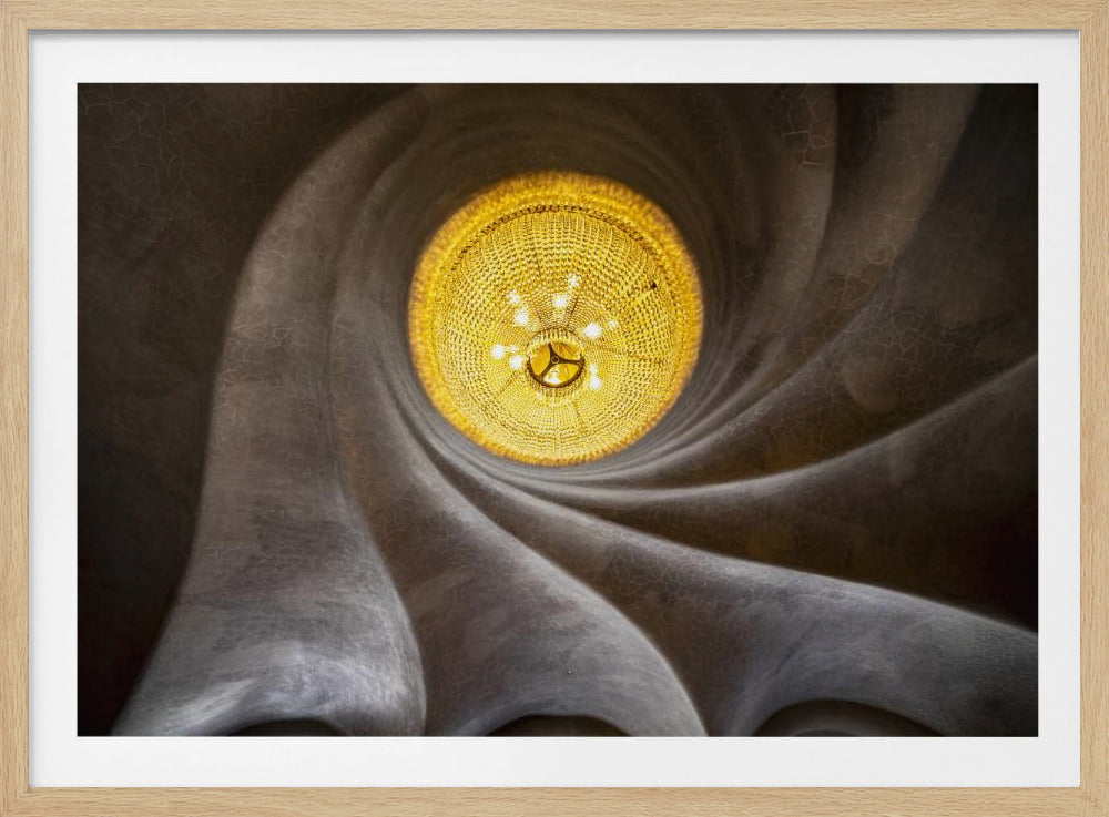 A worm's-eye view of an ornate, golden chandelier set against a swirling, textured dark grey ceiling. The spiraling architectural feature draws the eye to the brightly lit fixture, creating an abstract and dramatic composition. Poster