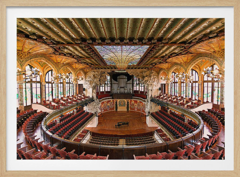 A high-angle, wide shot of the ornate and lavish interior of the Palau de la Música Catalana in Barcelona. The view captures the entire concert hall, with its curved balconies filled with red seats, a central wooden stage with a grand piano, and a spectacular, large stained-glass skylight in the ceiling. Poster