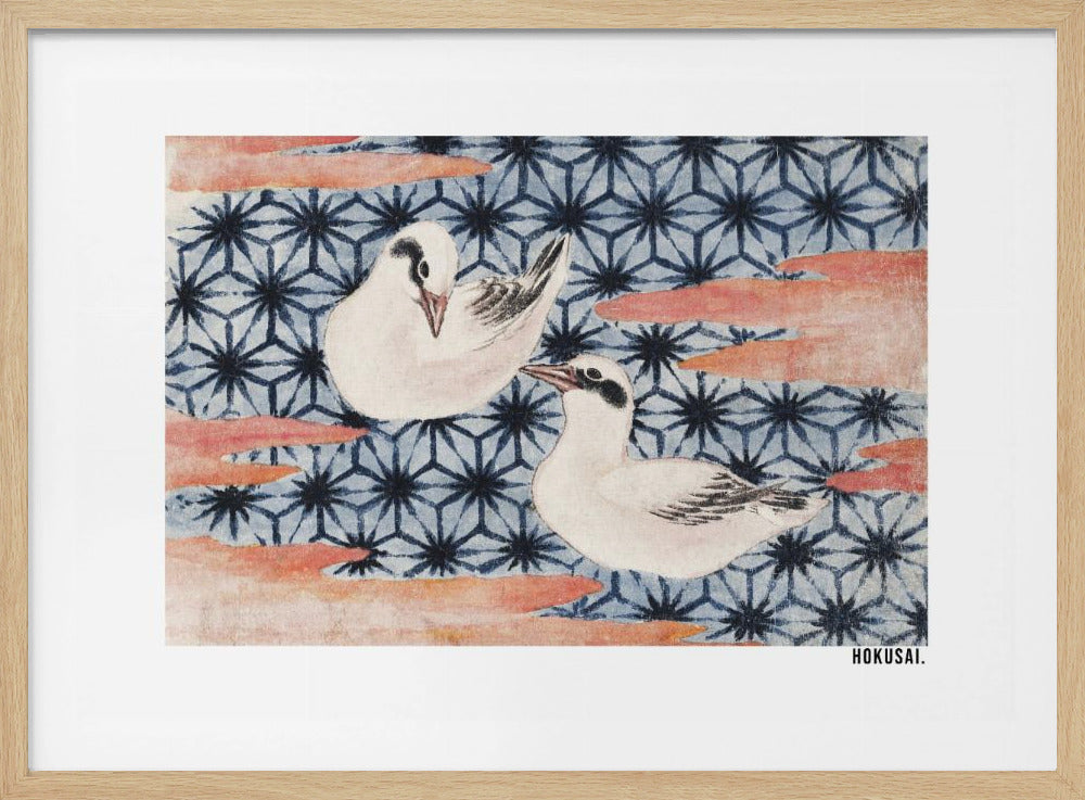 A classic Japanese woodblock print by Hokusai featuring two white birds with black eye markings resting on a background of a traditional blue Asanoha geometric pattern. Soft, reddish-orange cloud-like shapes float across the scene. Print