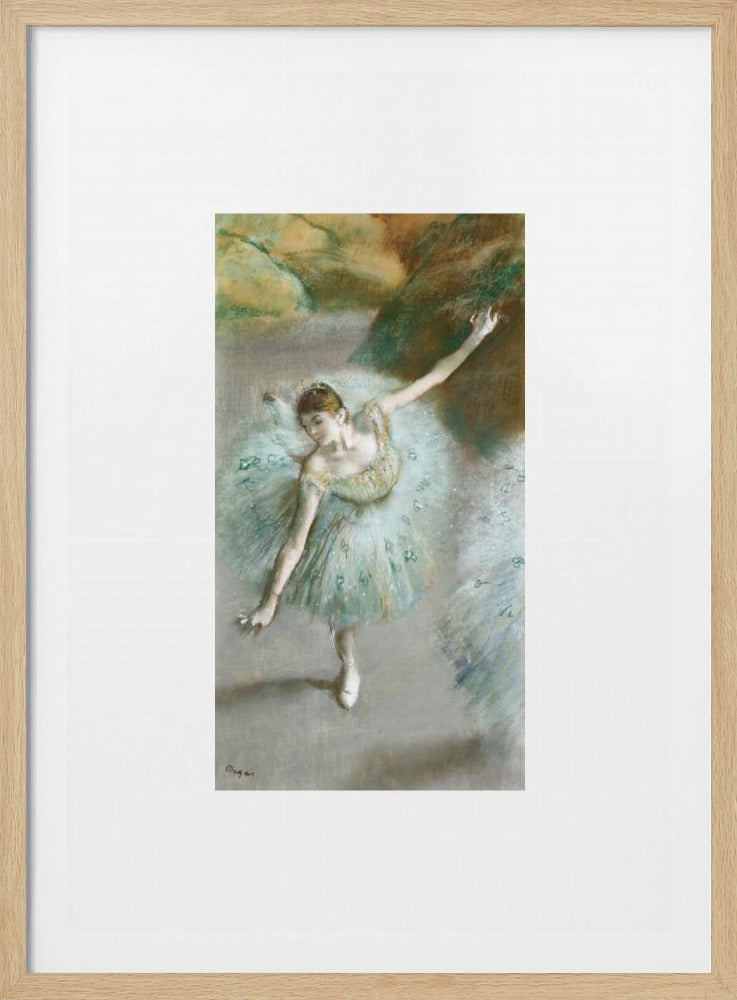 A framed vertical reproduction of an Edgar Degas painting showing a ballerina from a high angle. She wears a voluminous light blue tutu and is posed gracefully with arms outstretched against a soft, impressionistic background of earthy browns and tans. Poster
